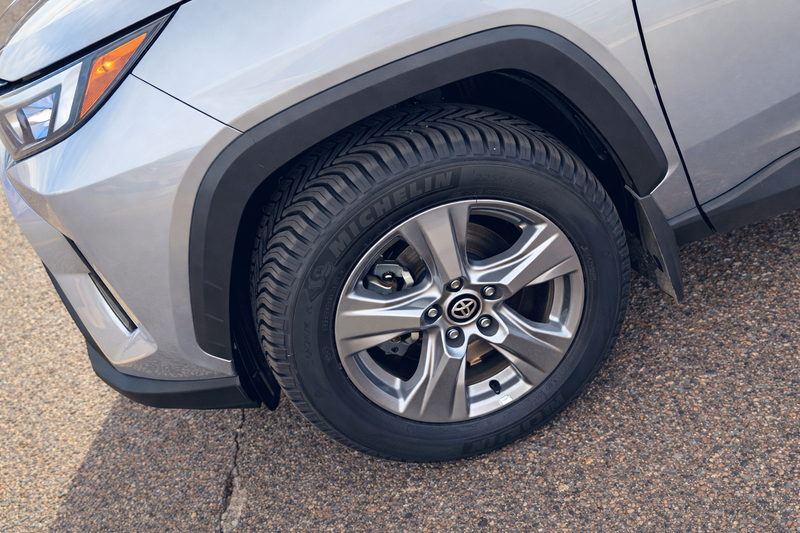 Close-up of a car tire with visible branding on a road surface